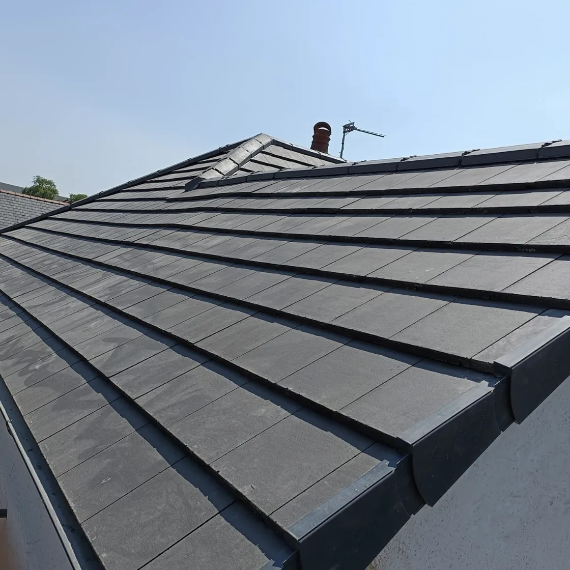Finished grey tiled roof and hip detail