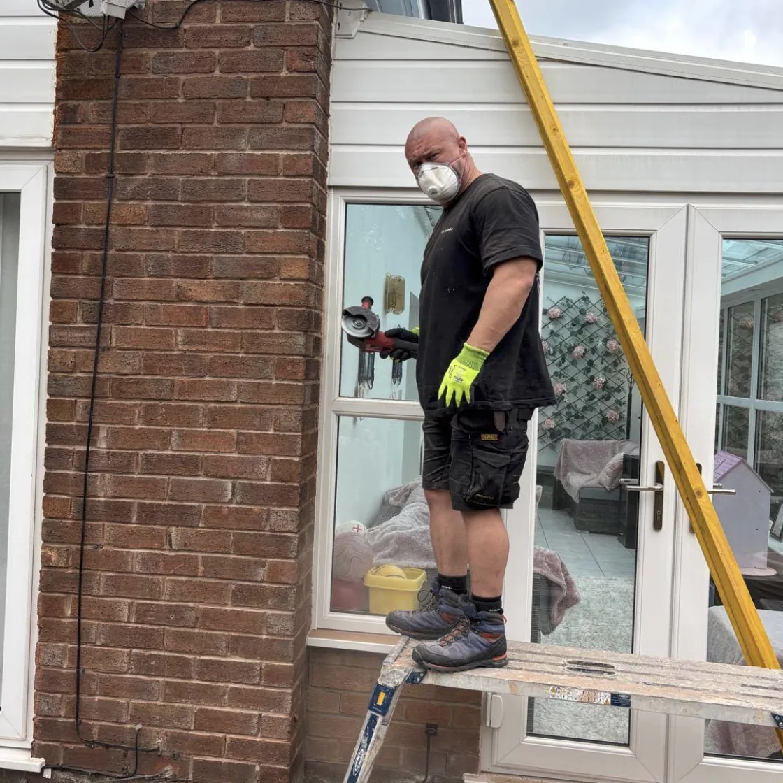 Tradesperson preparing exterior brickwork