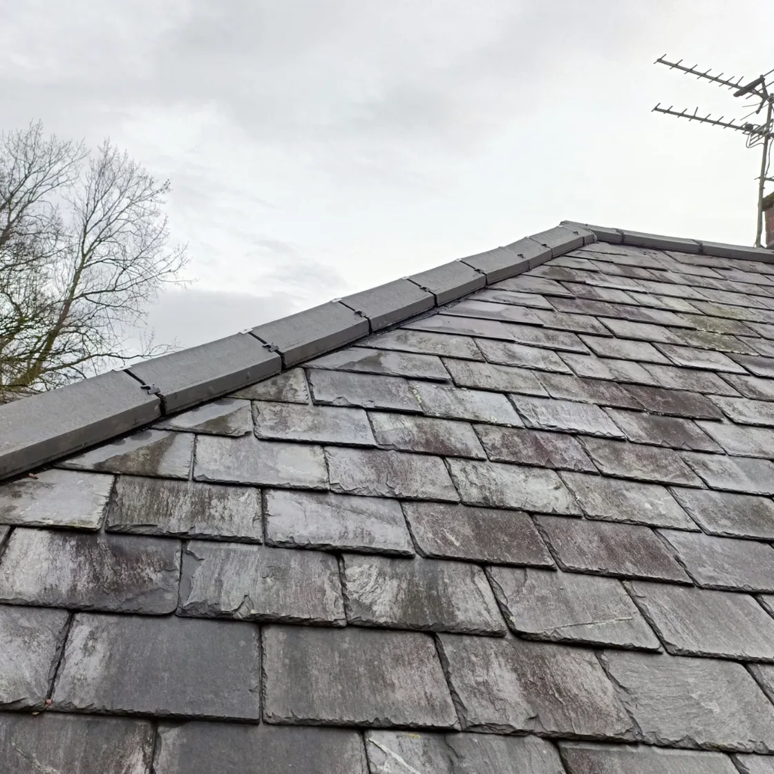Traditional slate roof with ridge tiles