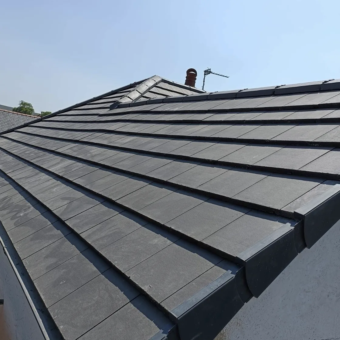Finished grey tiled roof viewed along the eaves