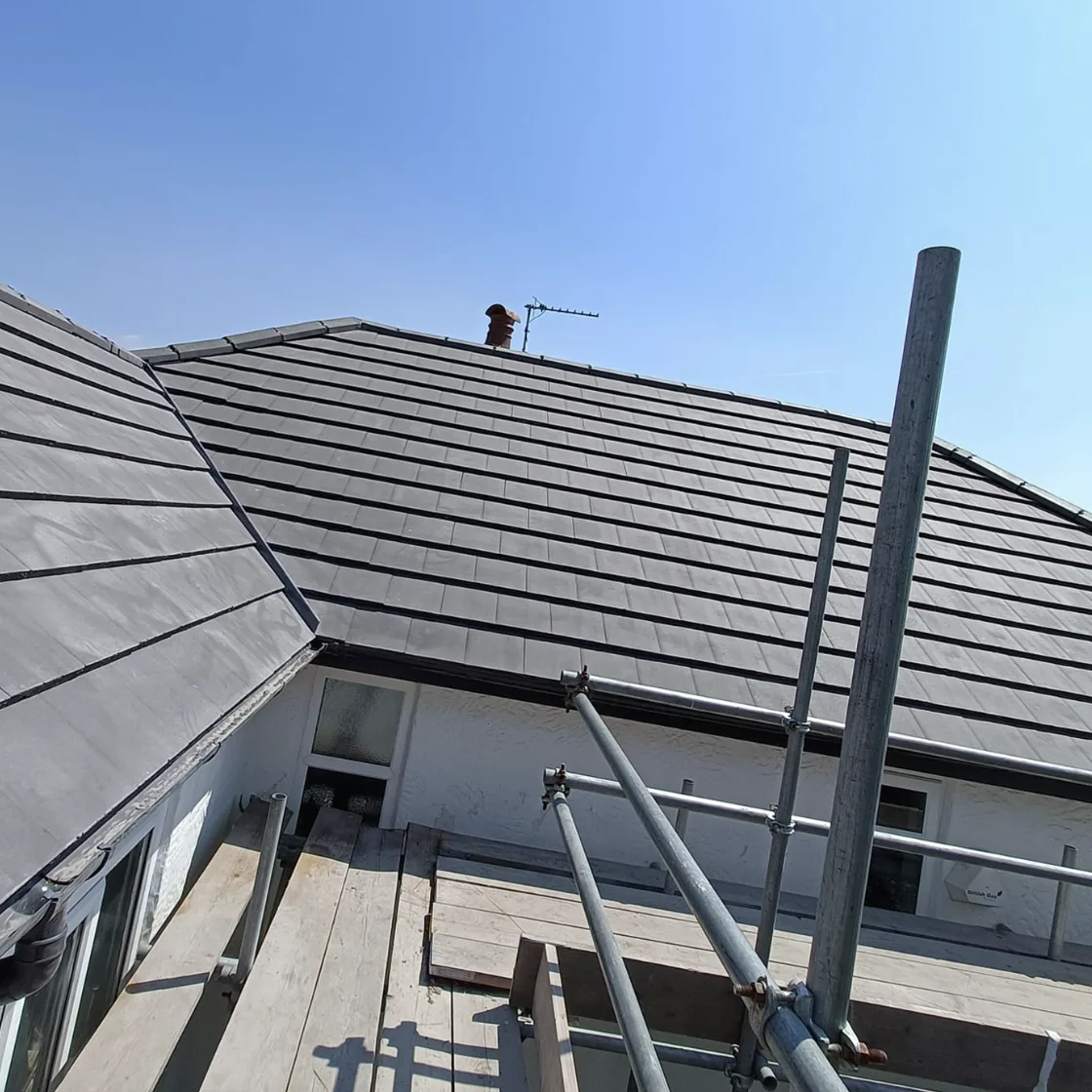 Grey tiled roof seen from the scaffolding