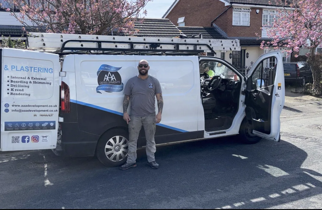 Kelvin standing in front of the AAA Developments van